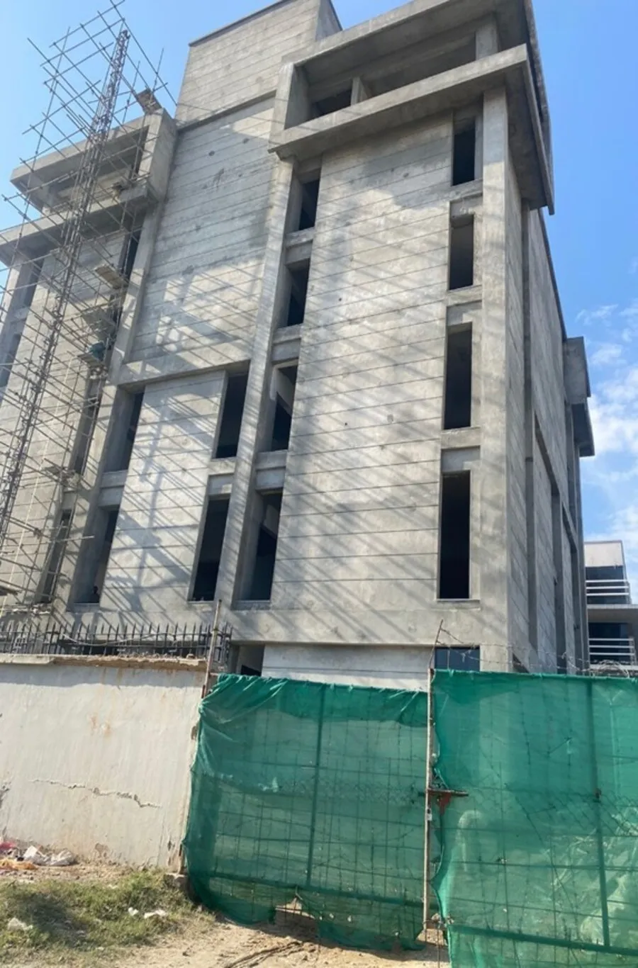 Fair-faced concrete facade with scaffolding