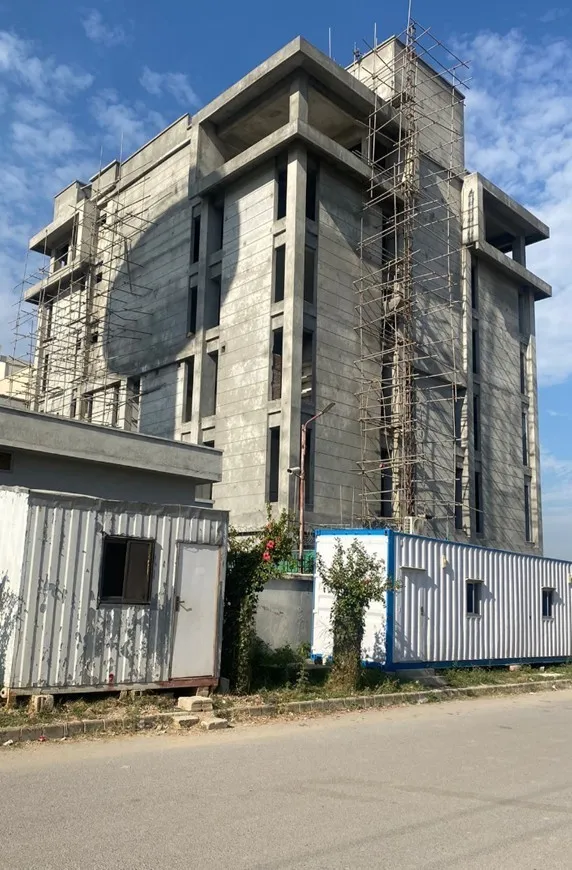 Building with site offices in the foreground