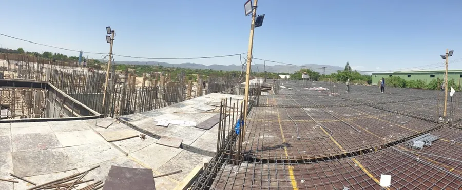 Slab reinforcement in progress across a large building footprint